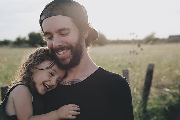 Man smiling with daughter