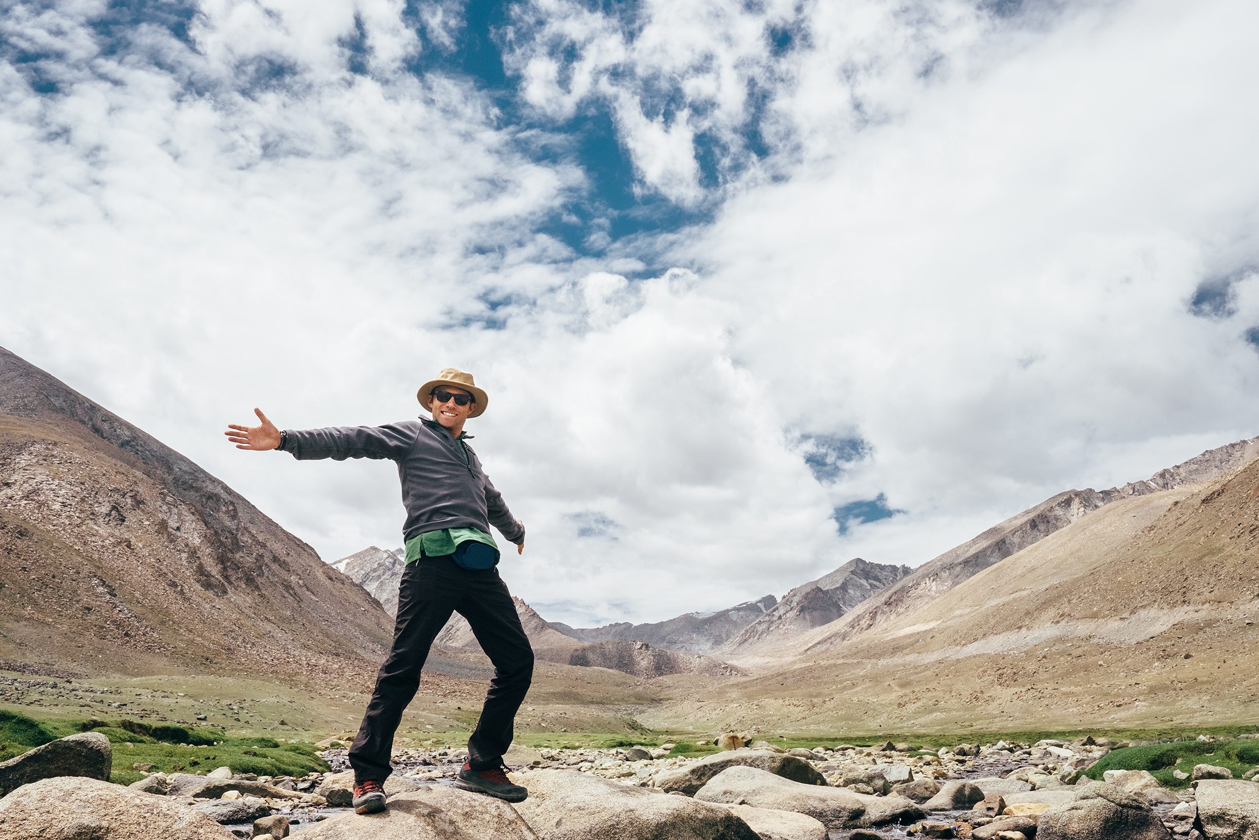 Happy traveler wide opened the arms and cheerful laughing in the indian Himalaya mountains